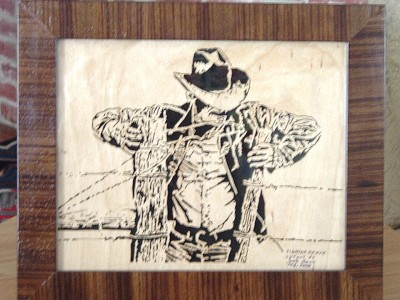 Cowboy tightening a fence